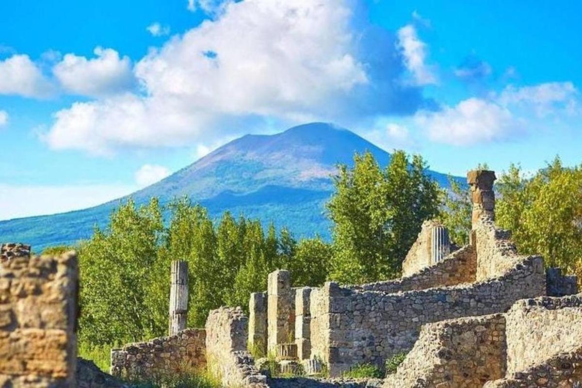 a stone wall with a mountain in the background