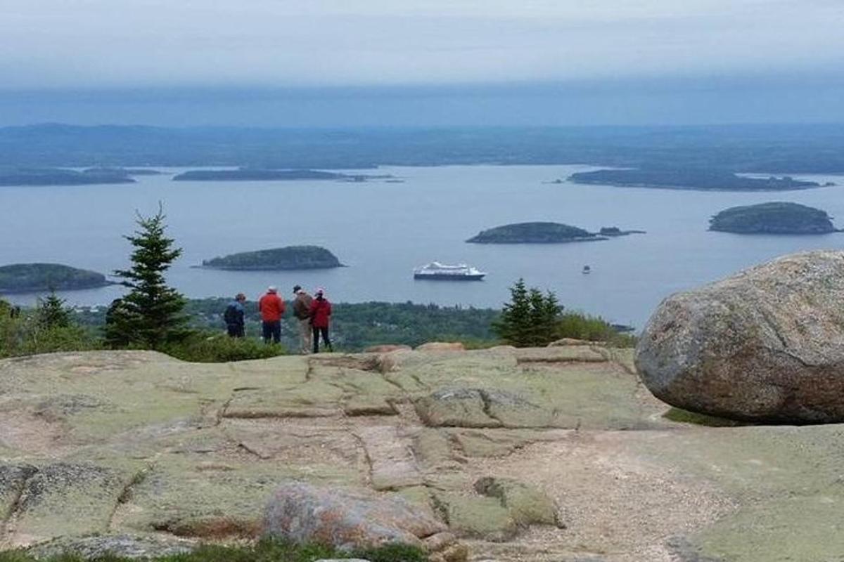 a group of people standing on top of a mountain
