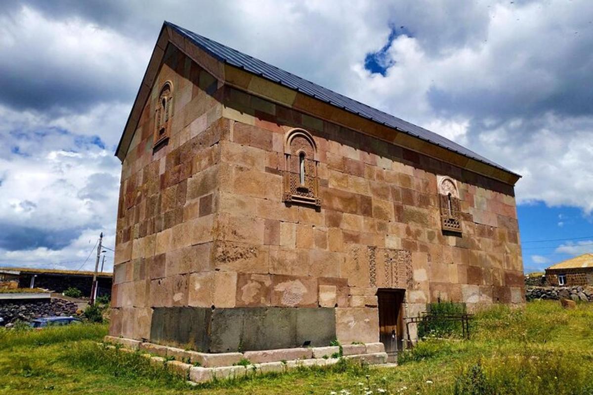 an old brick building sitting in a field
