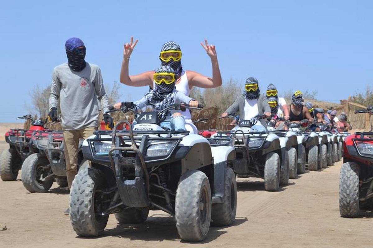 a group of people riding atvs on a dirt road