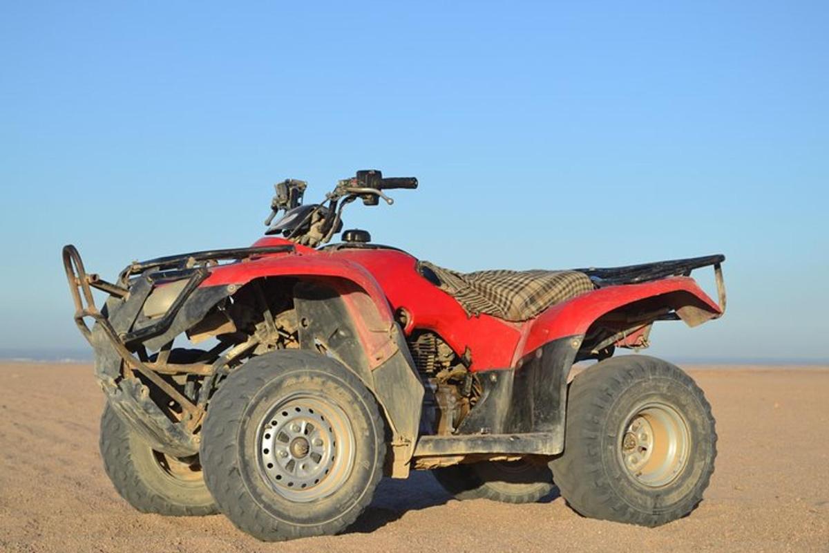 a red atv parked in the desert