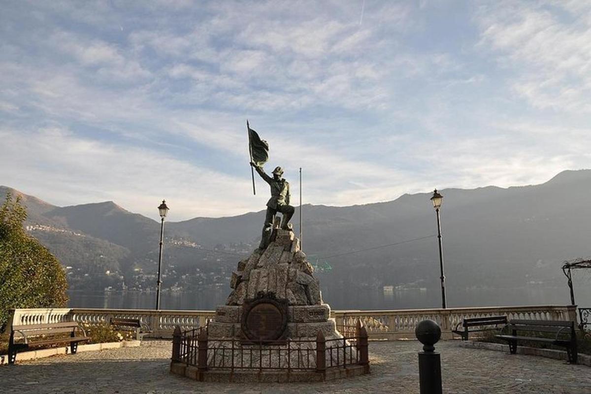 a statue of a man holding a flag on top