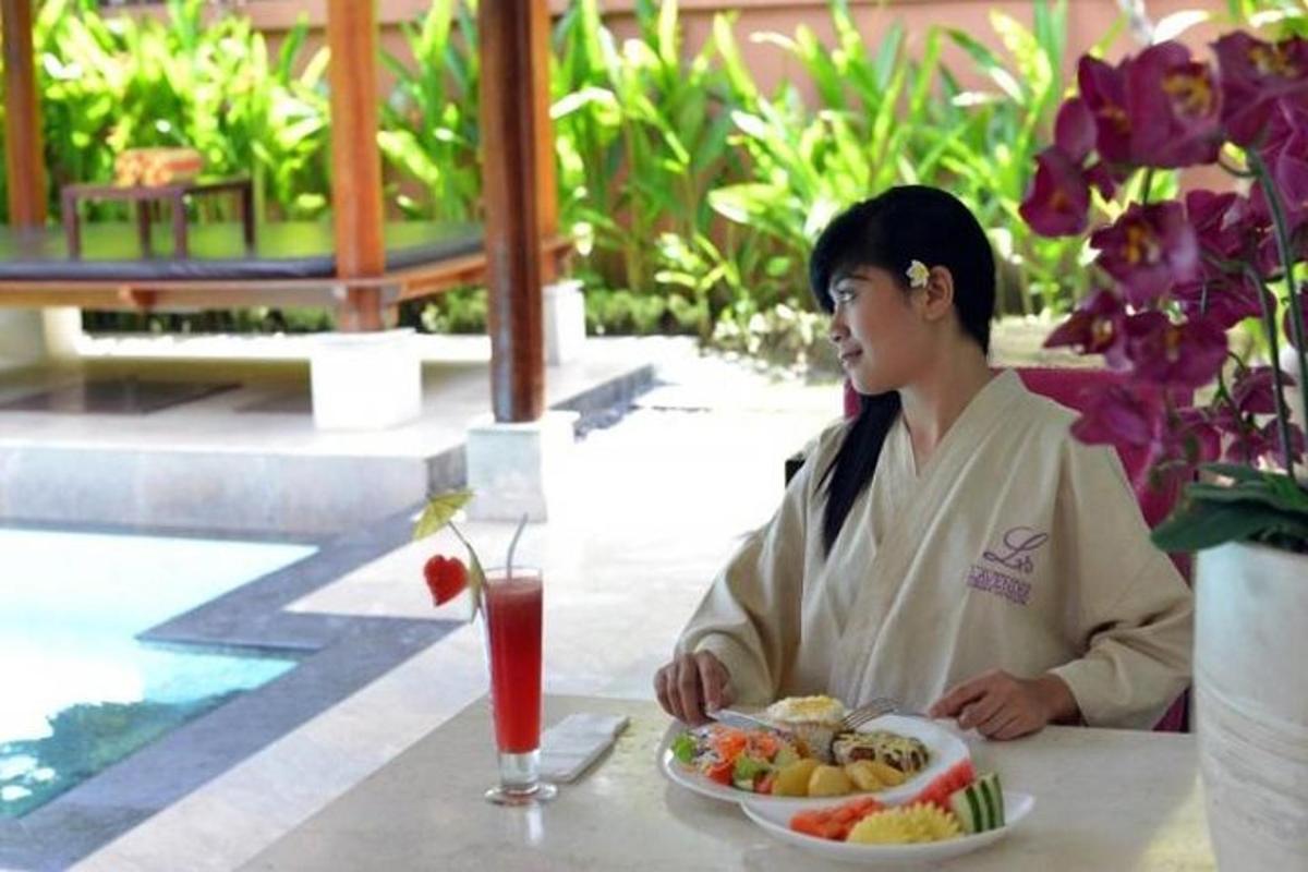 a woman sitting at a table with a plate of food
