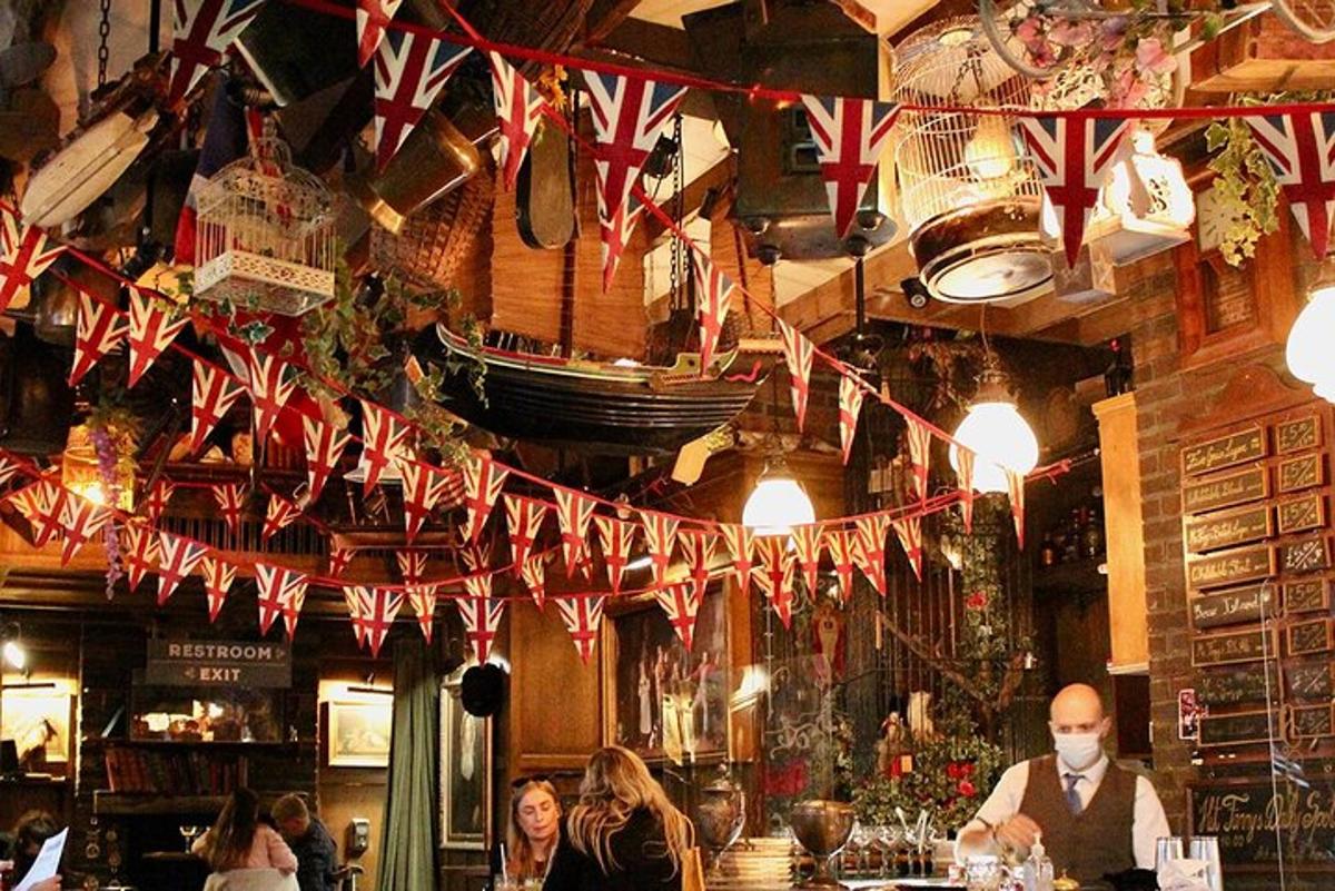 a bar with british flags hanging from the ceiling