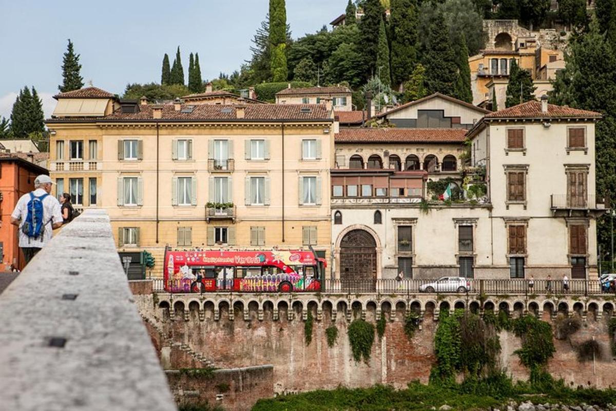 a red bus is parked in front of a building