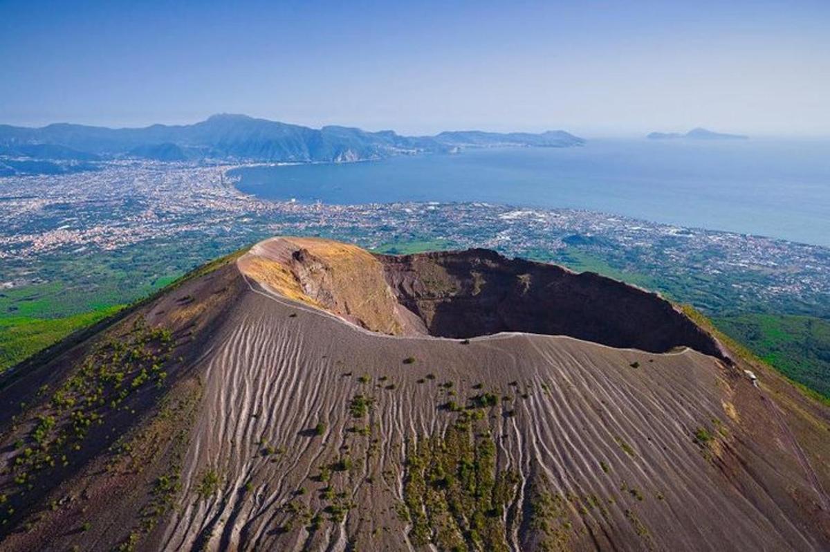 an aerial view of a dirt hill with the ocean