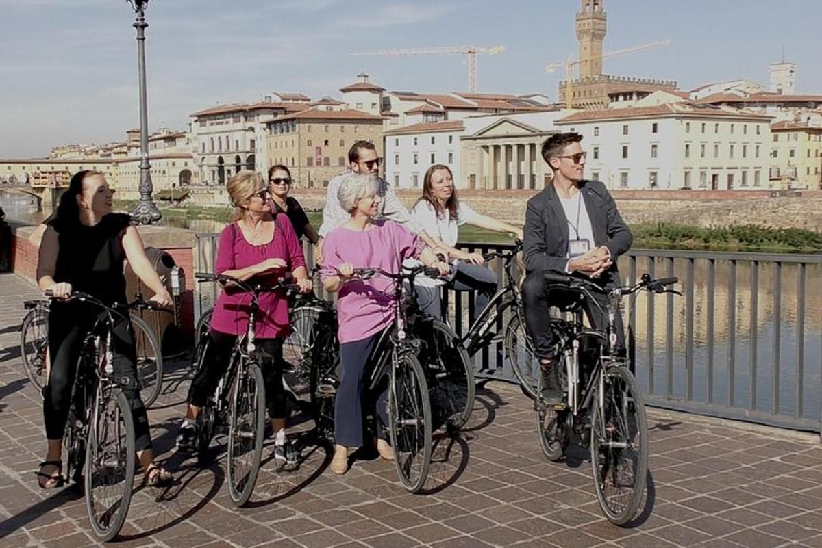a group of people riding bikes on a bridge