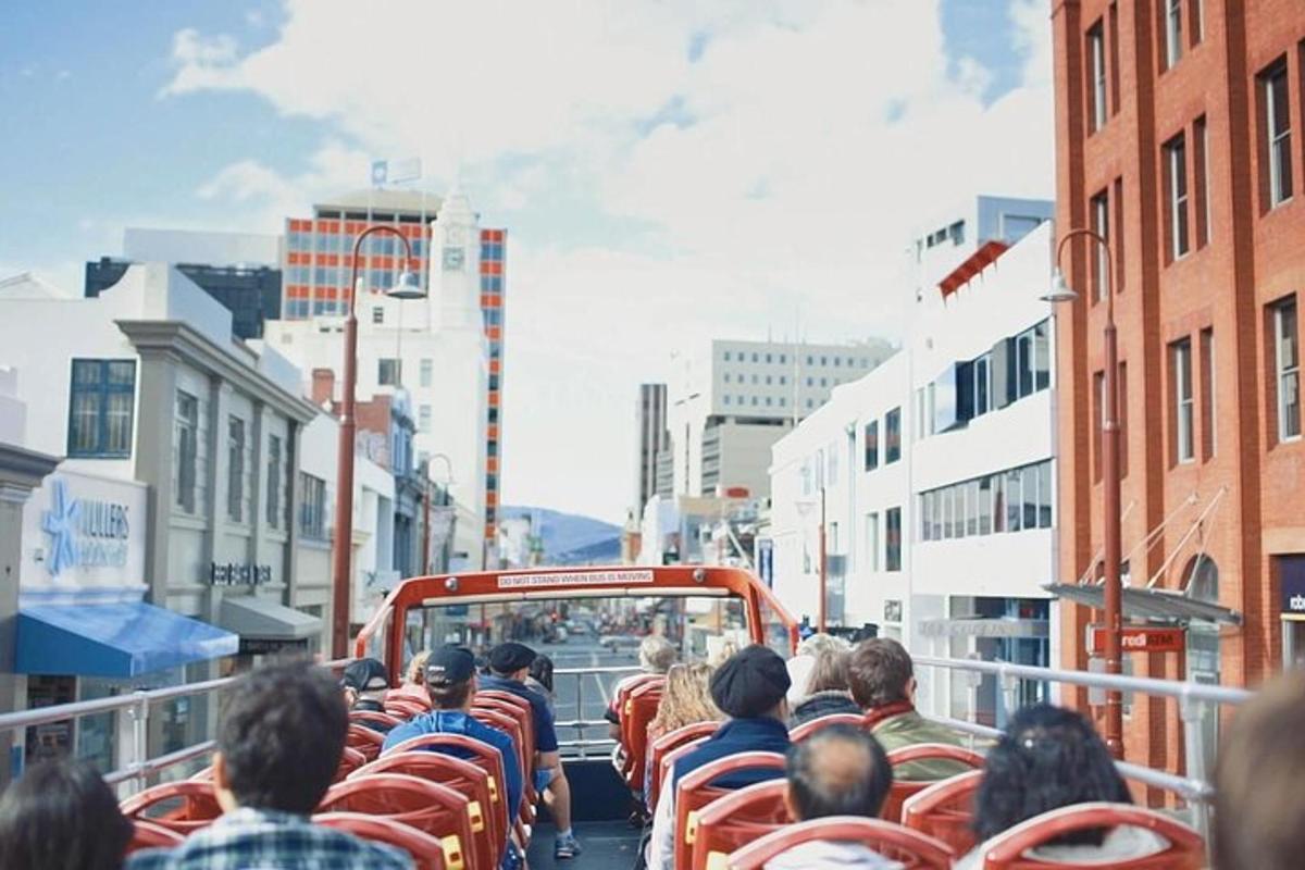 a group of people riding a bus down a city street