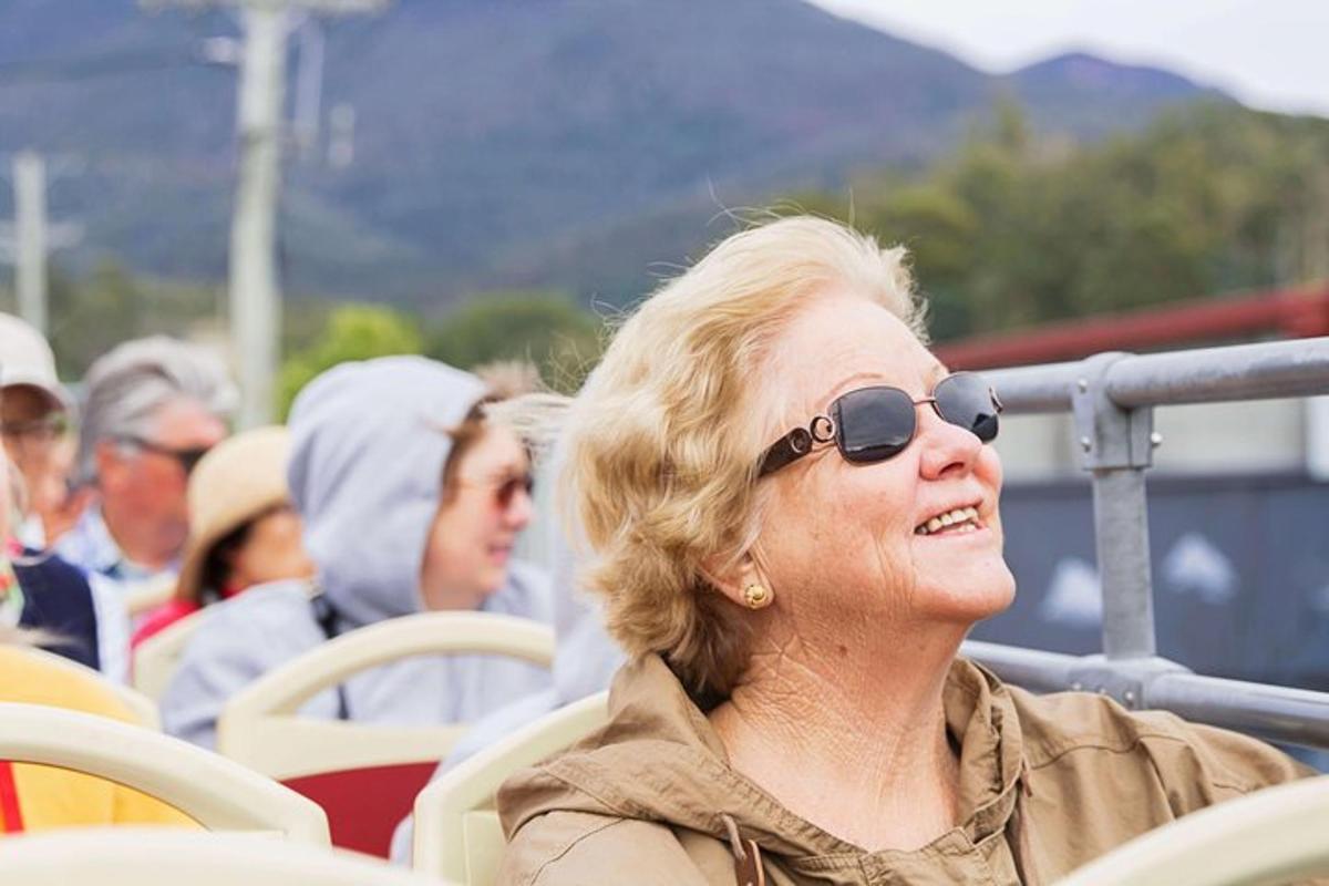 an older woman wearing sunglasses sitting on a boat