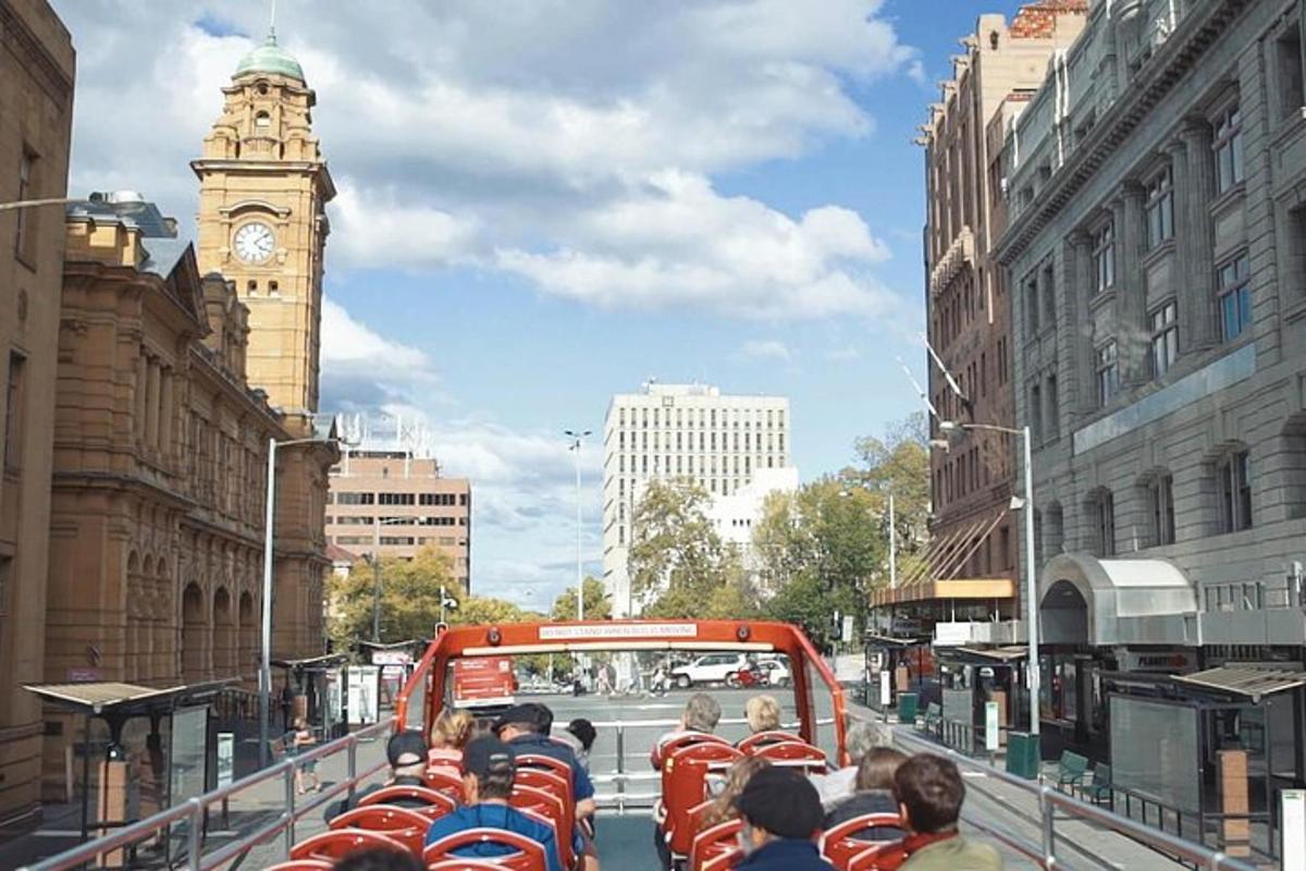 a group of people riding a bus down a city street