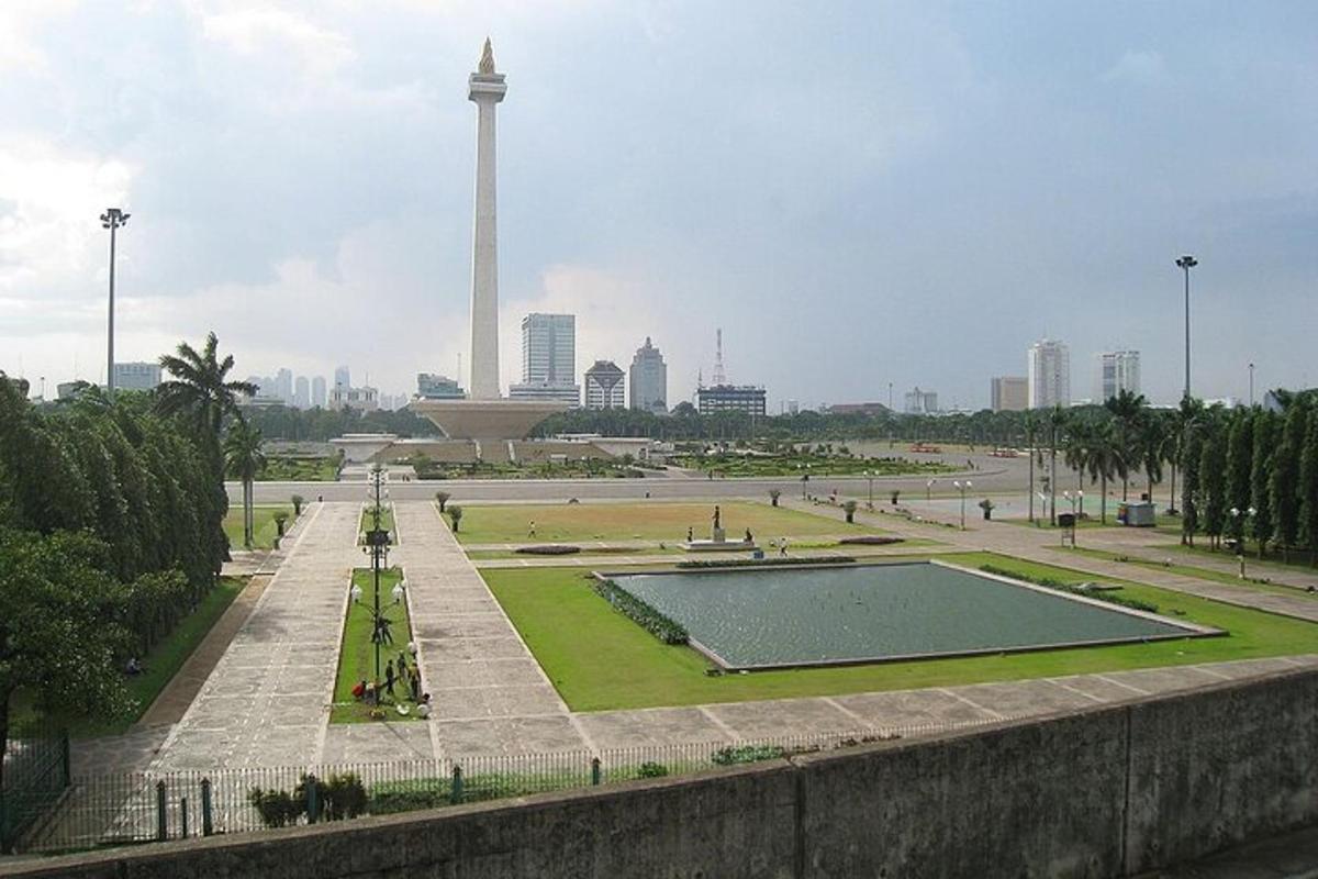 a view of a park with a tower in the background