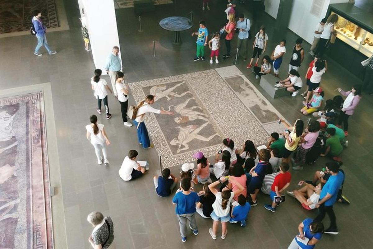 a crowd of people looking at a painting in a museum