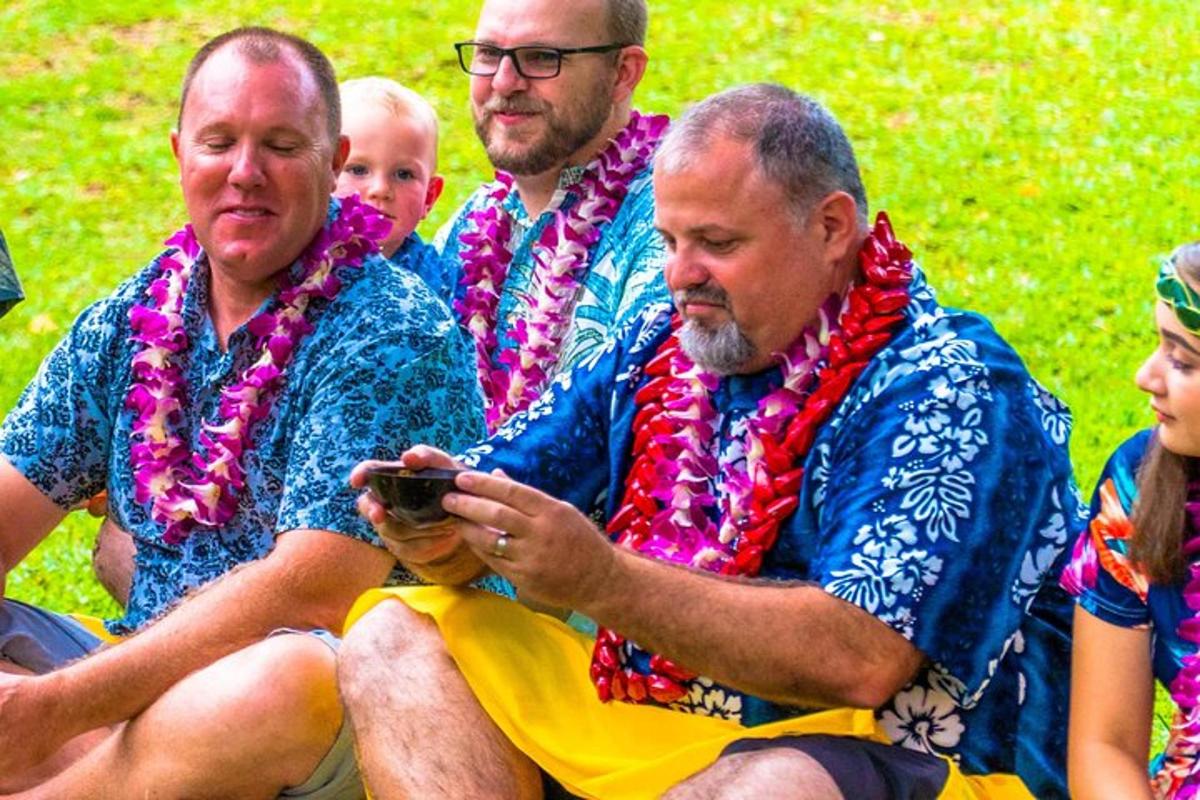 a group of people wearing bandanas looking at a cell phone