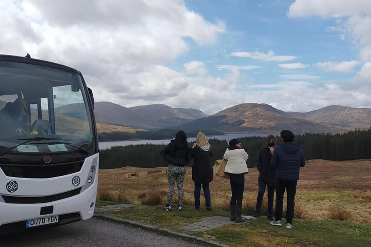a group of people standing in front of a bus