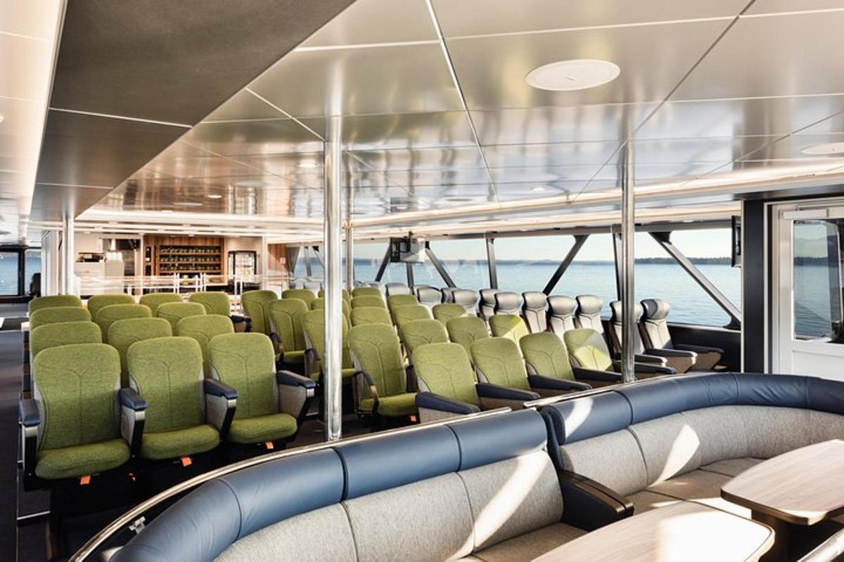 a room with green chairs on a boat