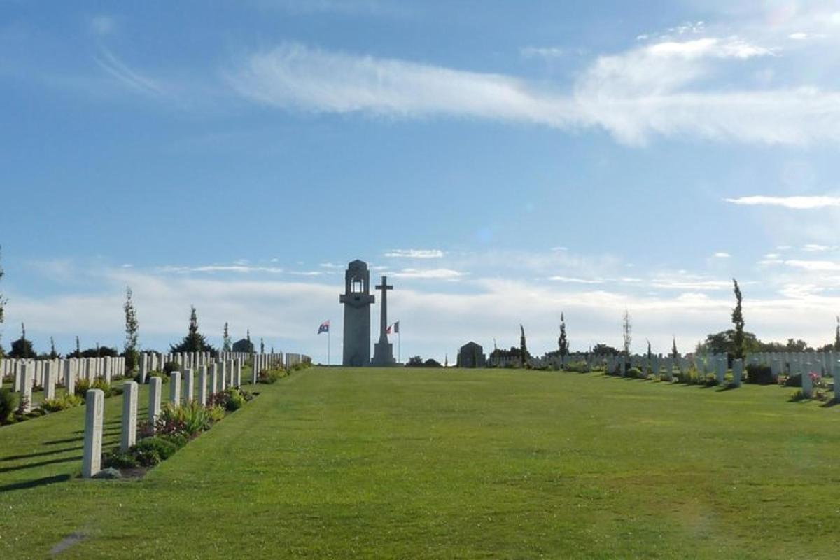 a cemetery with a clock tower in the distance
