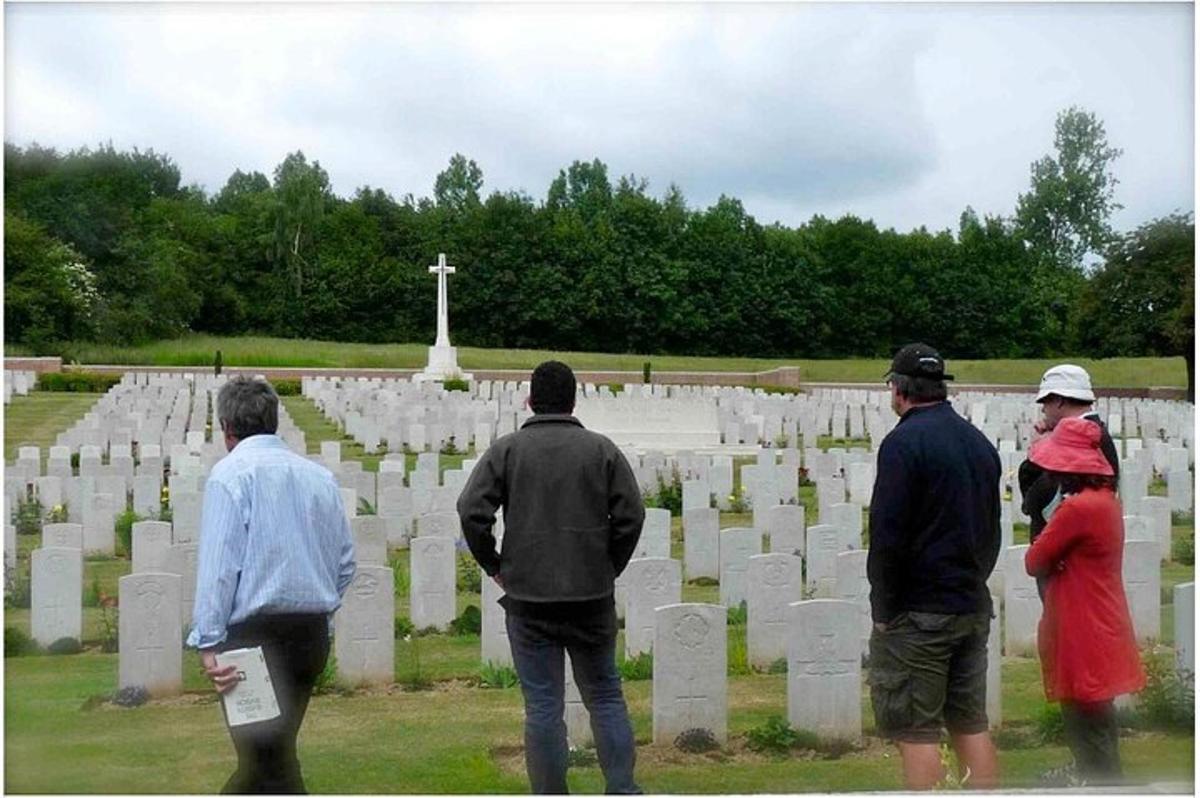 a group of people standing in a cemetery