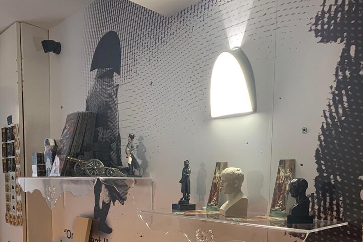 a room with a shelf with statues and a light