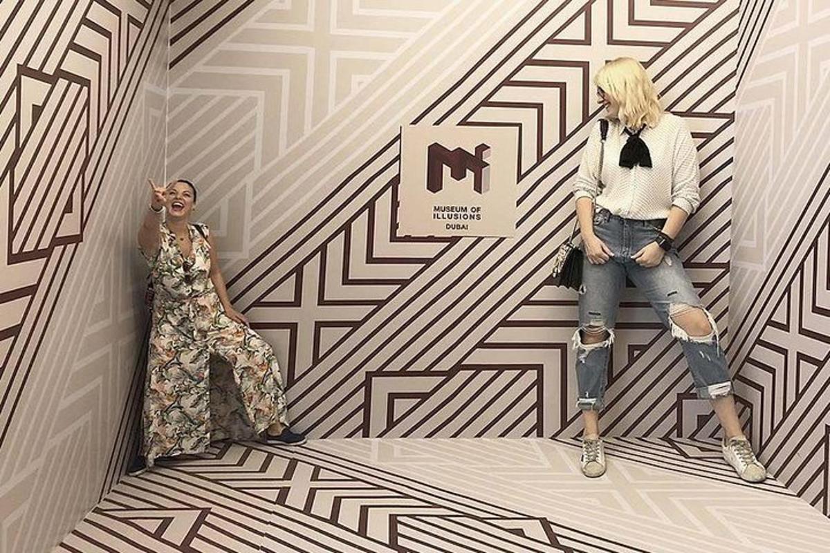 two women standing next to each other in a room