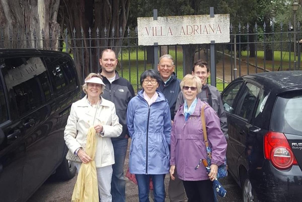 a group of people standing in front of a car