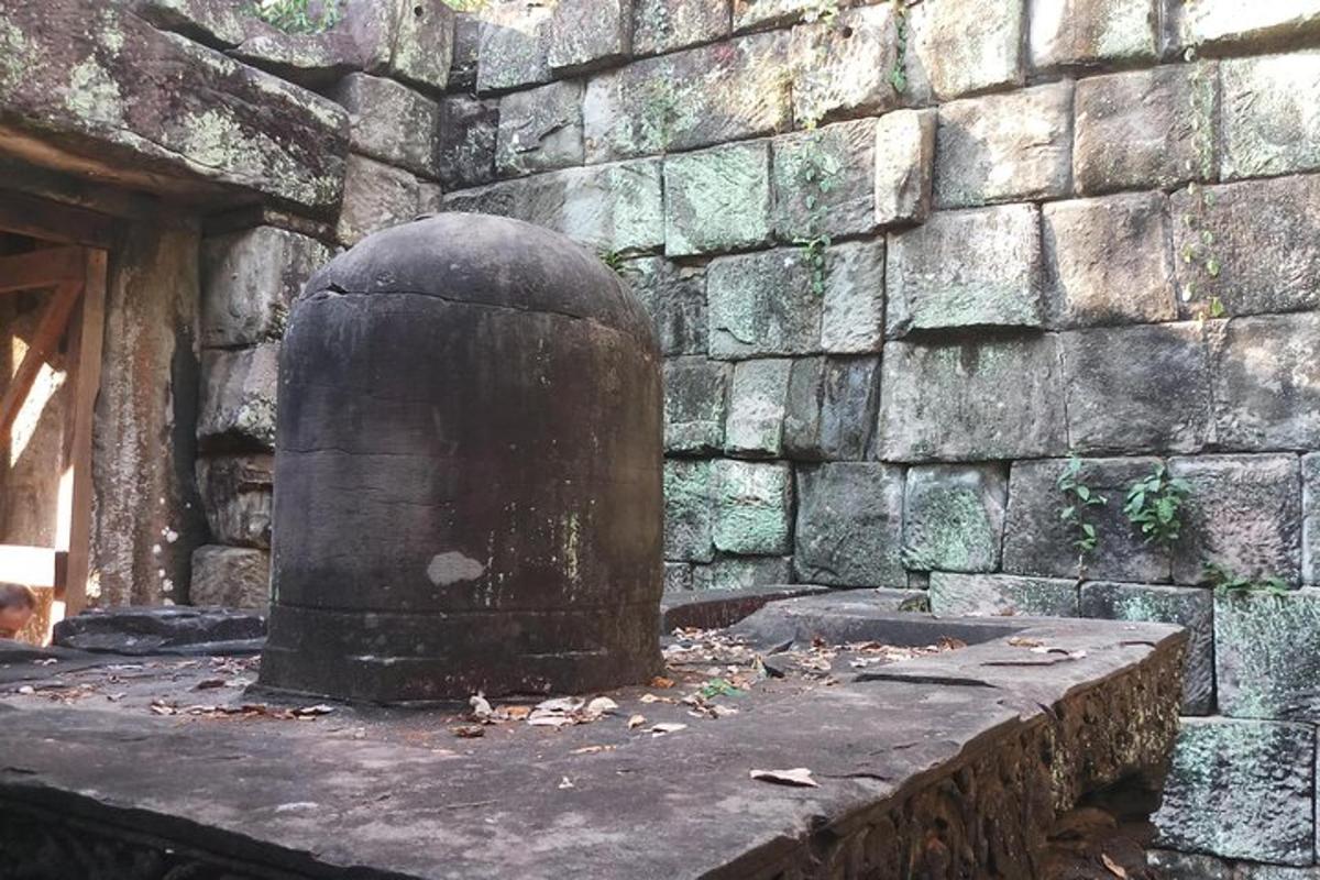 a stone wall with a large object in front of it
