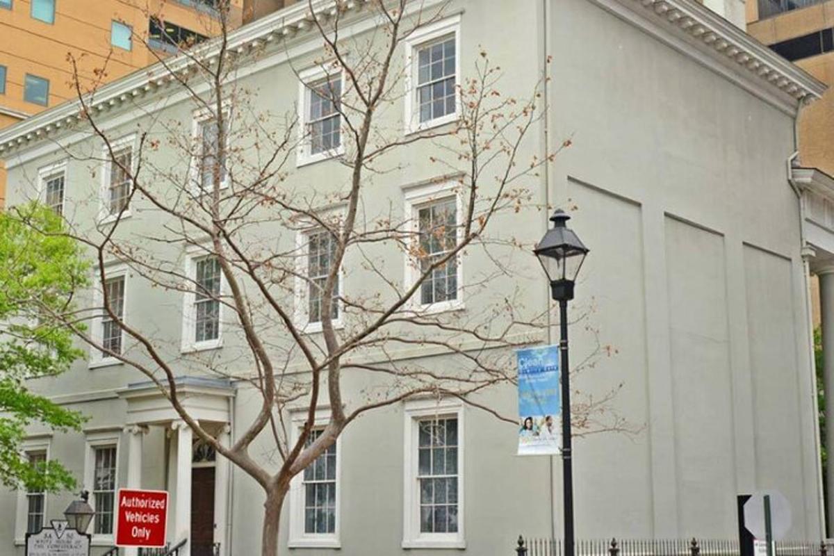 a white building with a tree in front of it
