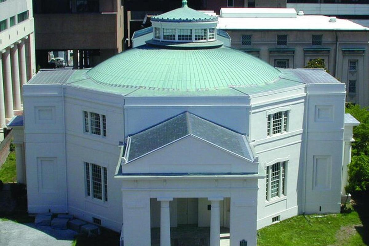 a large white building with a green roof