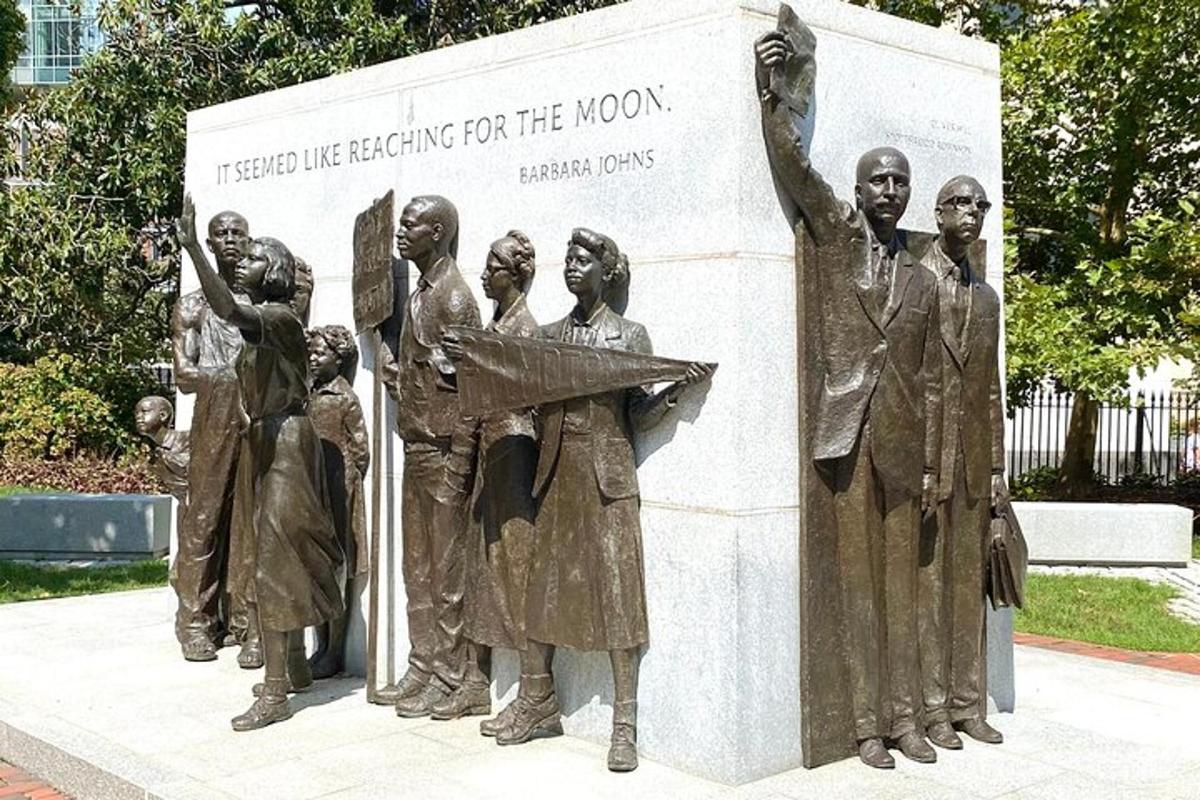 a statue of a group of people standing in front of a monument