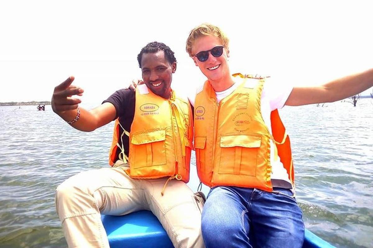 two men in life jackets sitting on a raft in the water