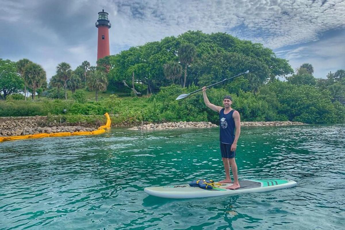 a man holding a paddle on a surfboard in the water