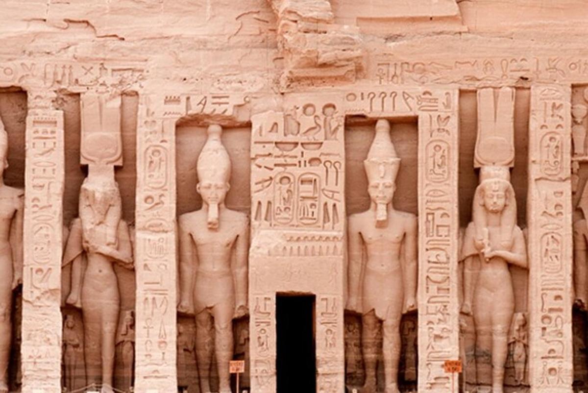 a stone wall with a bunch of statues on it