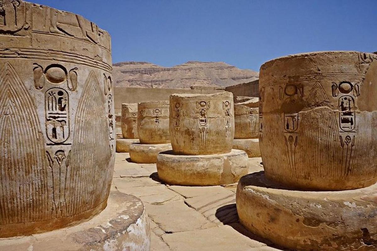 a group of cement pillars in the desert