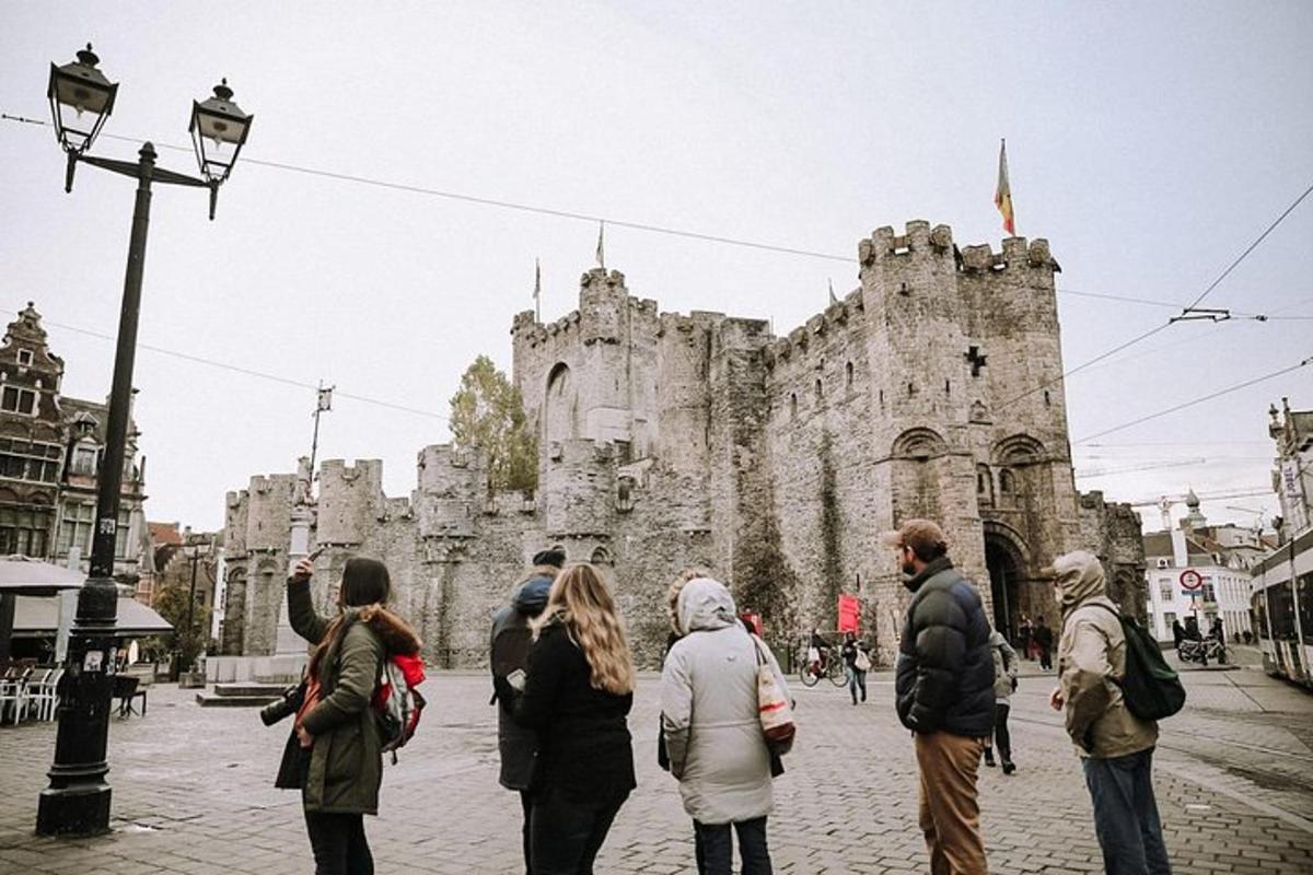 a group of people standing in front of an old castle