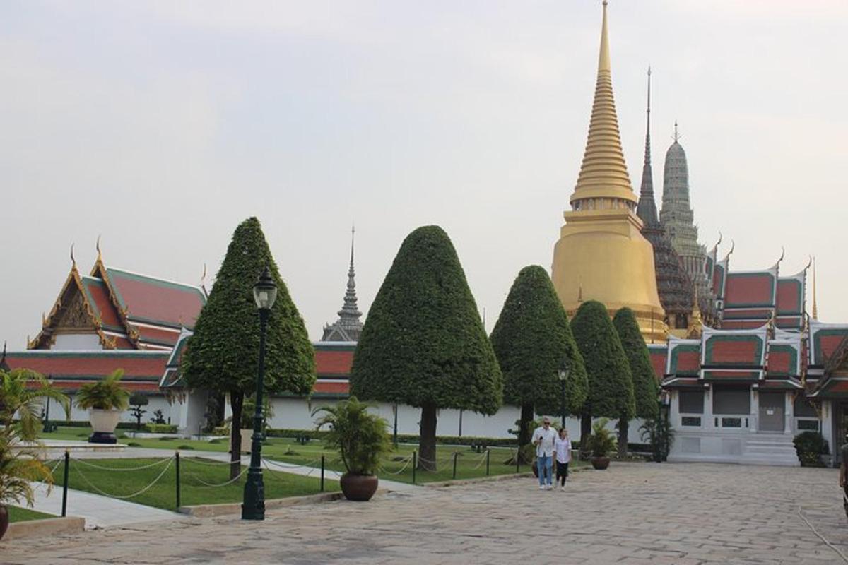 a group of people walking in front of a temple