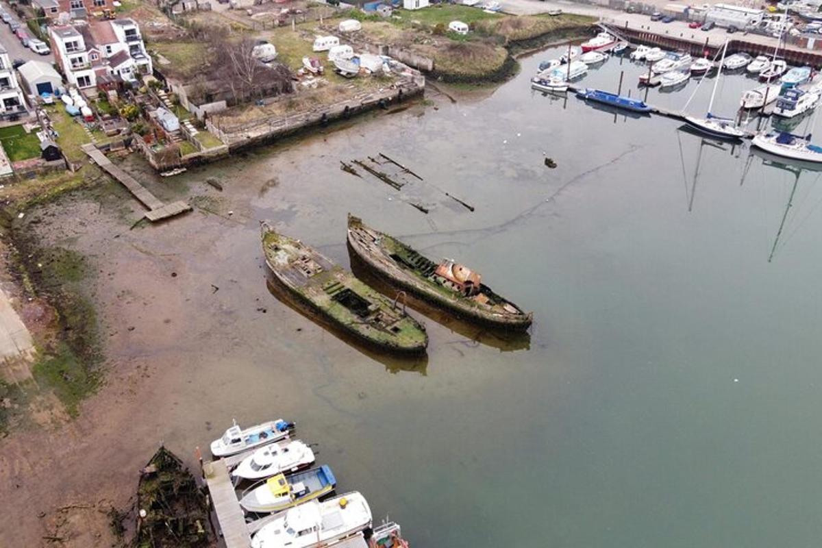 a group of boats in the water next to a harbor
