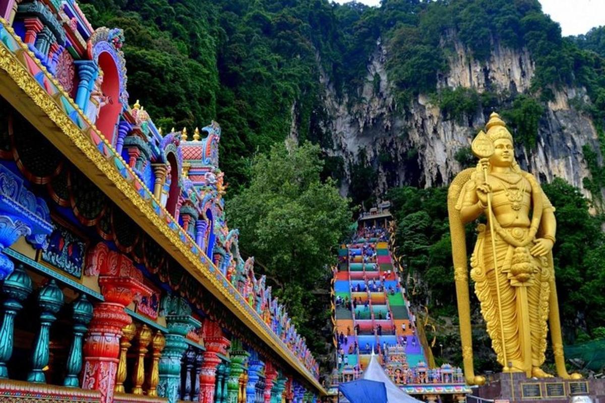a large statue in front of a building with a mountain