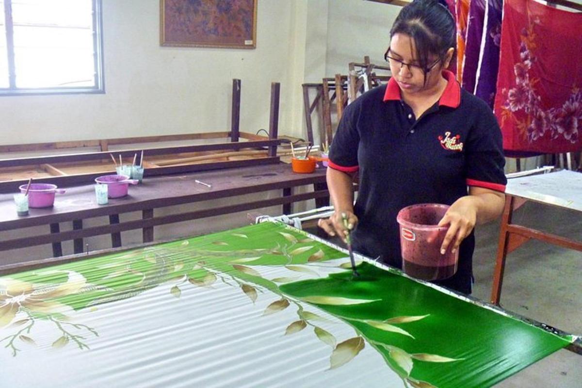 a woman cutting a green leaf on a table