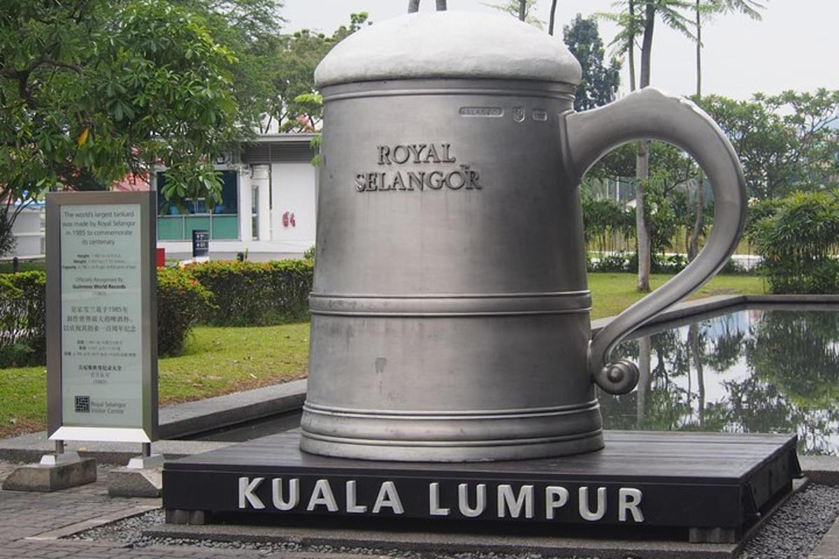 a statue of a large mug in a park