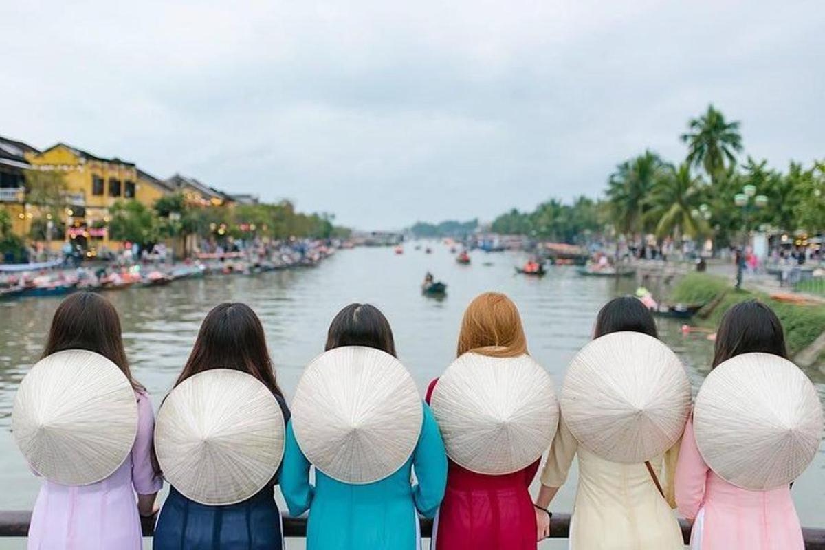 a group of women standing in front of a river