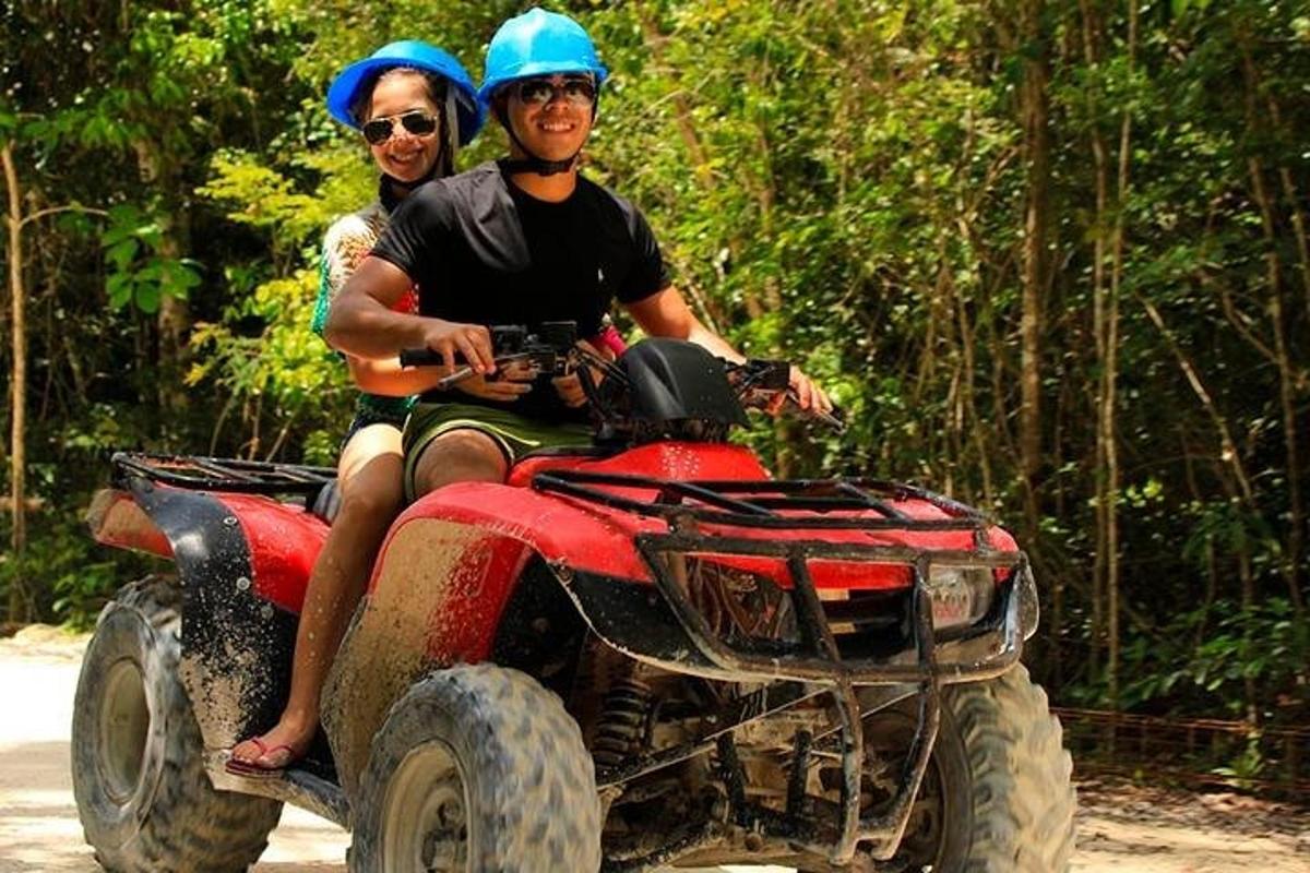 a man and a woman riding on a four wheeler