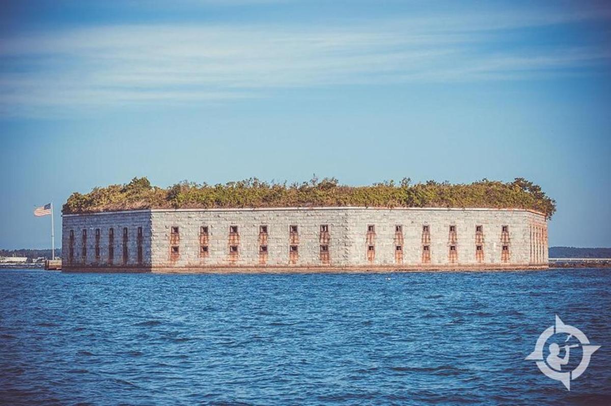 a large brick building in the middle of the water