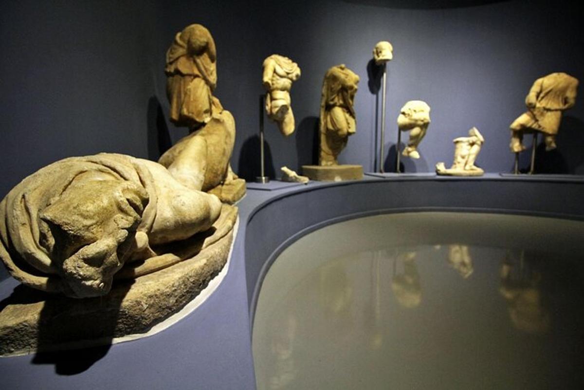a group of statues on display in a museum