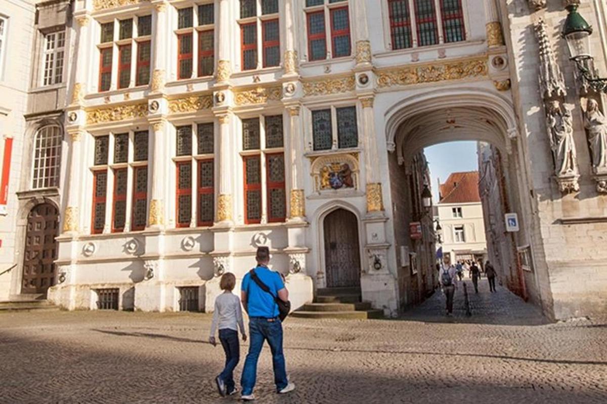 a man and a boy walking in front of a building