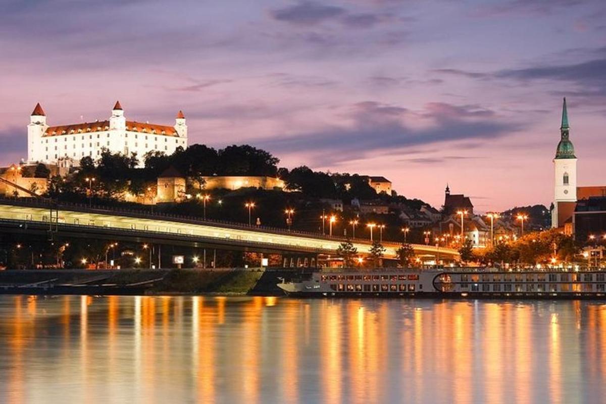 a city at night with a river and buildings