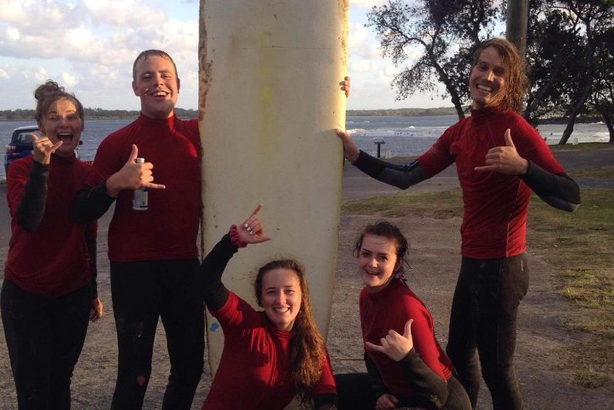a group of people standing around a pole