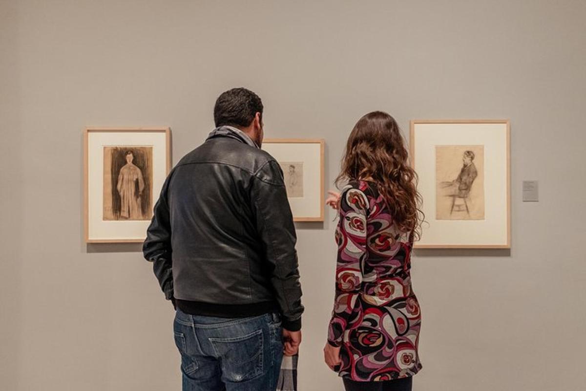 um homem e uma mulher olhando fotos em um museu