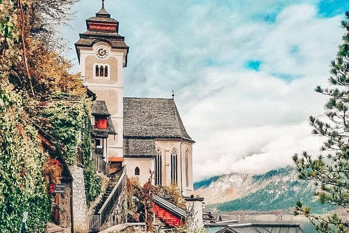 a church with a clock tower on a hill