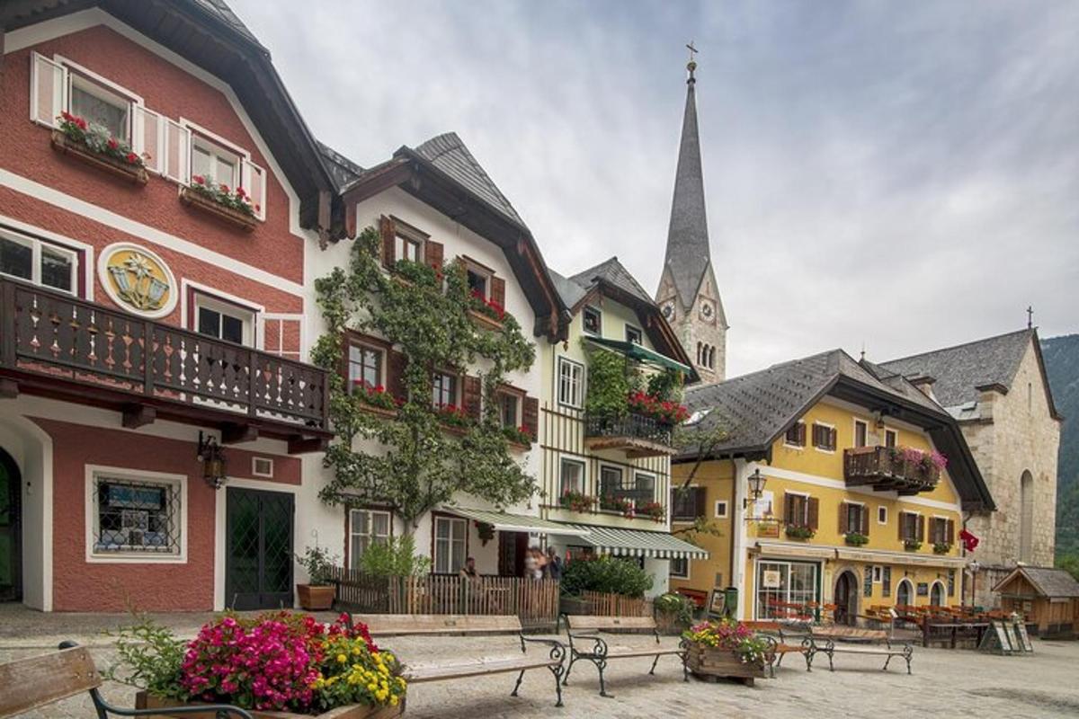 a group of buildings with benches and a church