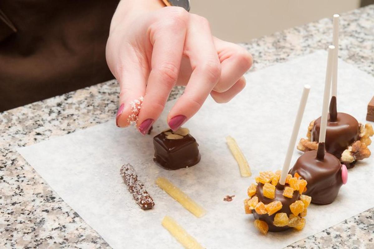 a person reaching for chocolate and peanuts on a table