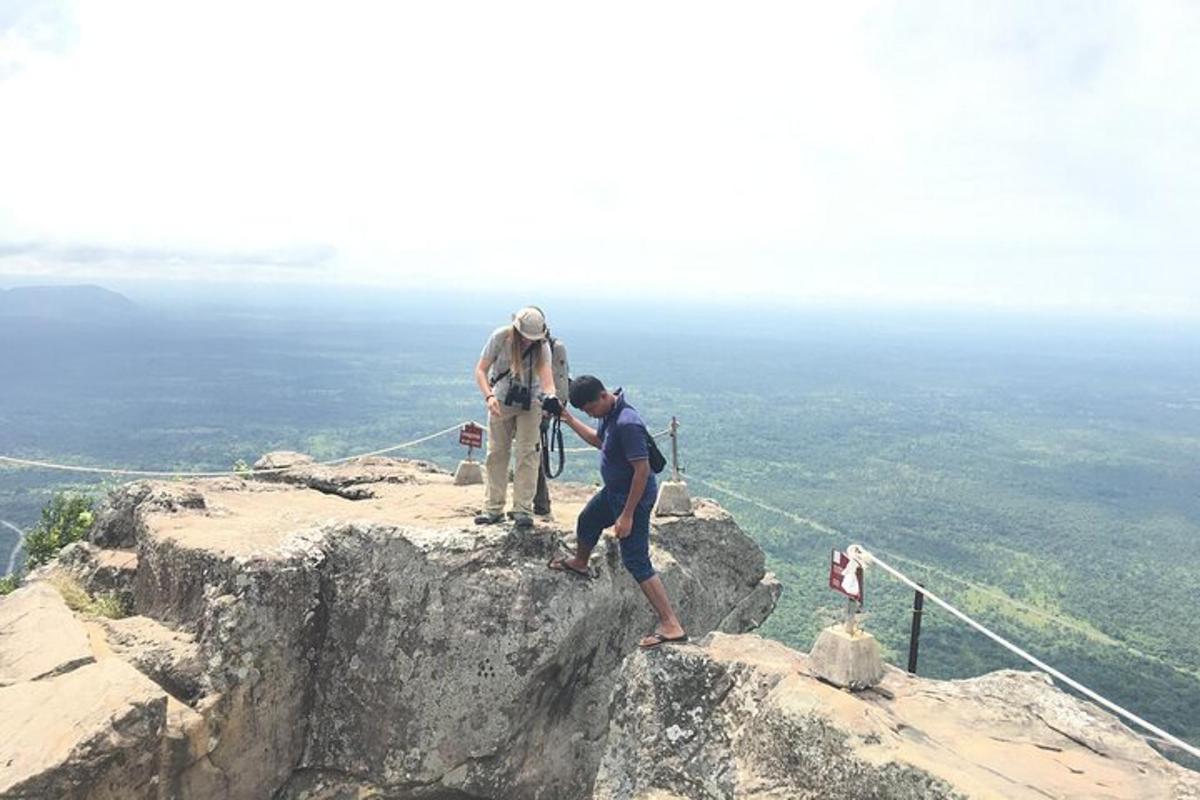 two people standing on top of a mountain